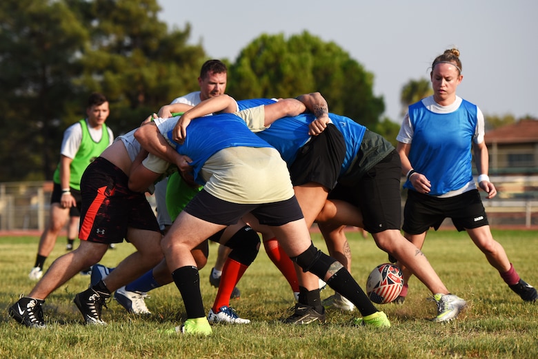 Airmen conduct a scrum during a rugby game Sept. 14, 2019, at Incirlik Air Base, Turkey. Scrums are maneuvers in which players of two opposing teams pack tightly together, tuck their heads down and joust for possession of the ball by trying to hook it backward with their feet. (U.S. Air Force Photo by Staff Sgt. Joshua Magbanua)
