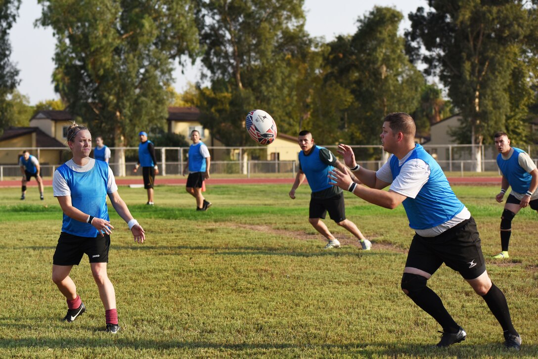 U.S. Airmen pass a rugby ball during a game Sept. 14, 2019, at Incirlik Air Base, Turkey. Rugby football is a contact sport which began in the town of Rugby, England, in the mid-1800s. (U.S. Air Force Photo by Staff Sgt. Joshua Magbanua)