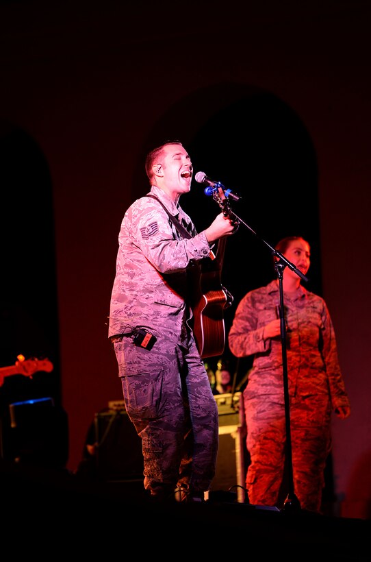 Tech. Sgt. Nick Daniels, U.S. Air Force Band of the West’s Top Flight vocalist, sings while playing an acoustic guitar during the Top Flight concert at the Columbus Riverwalk Stage Sept. 27, 2019, in Columbus, Miss. Top Flight travels over 30,000 miles annually performing throughout Texas, Oklahoma, Louisiana, Mississippi, Alabama, Georgia, Florida, and Puerto Rico. (U.S. Air Force photo by Airman 1st Class Hannah Bean)