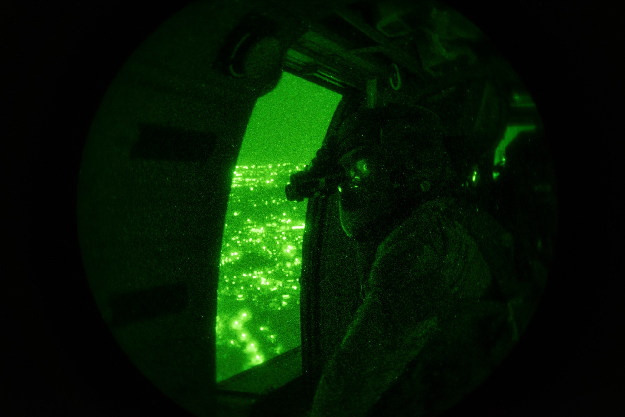 U.S. Air Force Tech. Sgt. Keon Miller, 33rd Rescue Squadron special missions aviator instructor, scans for aerial threats Sept. 18, 2019, over Okinawa, Japan. The 33rd RQS maintains a constant state of readiness and trains regularly to ensure mission success when called into action. (U.S. Air Force photo by Senior Airman Rhett Isbell)