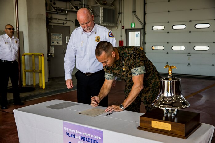 Colonel Fredrick Lewis signs Fire Prevention Proclamation