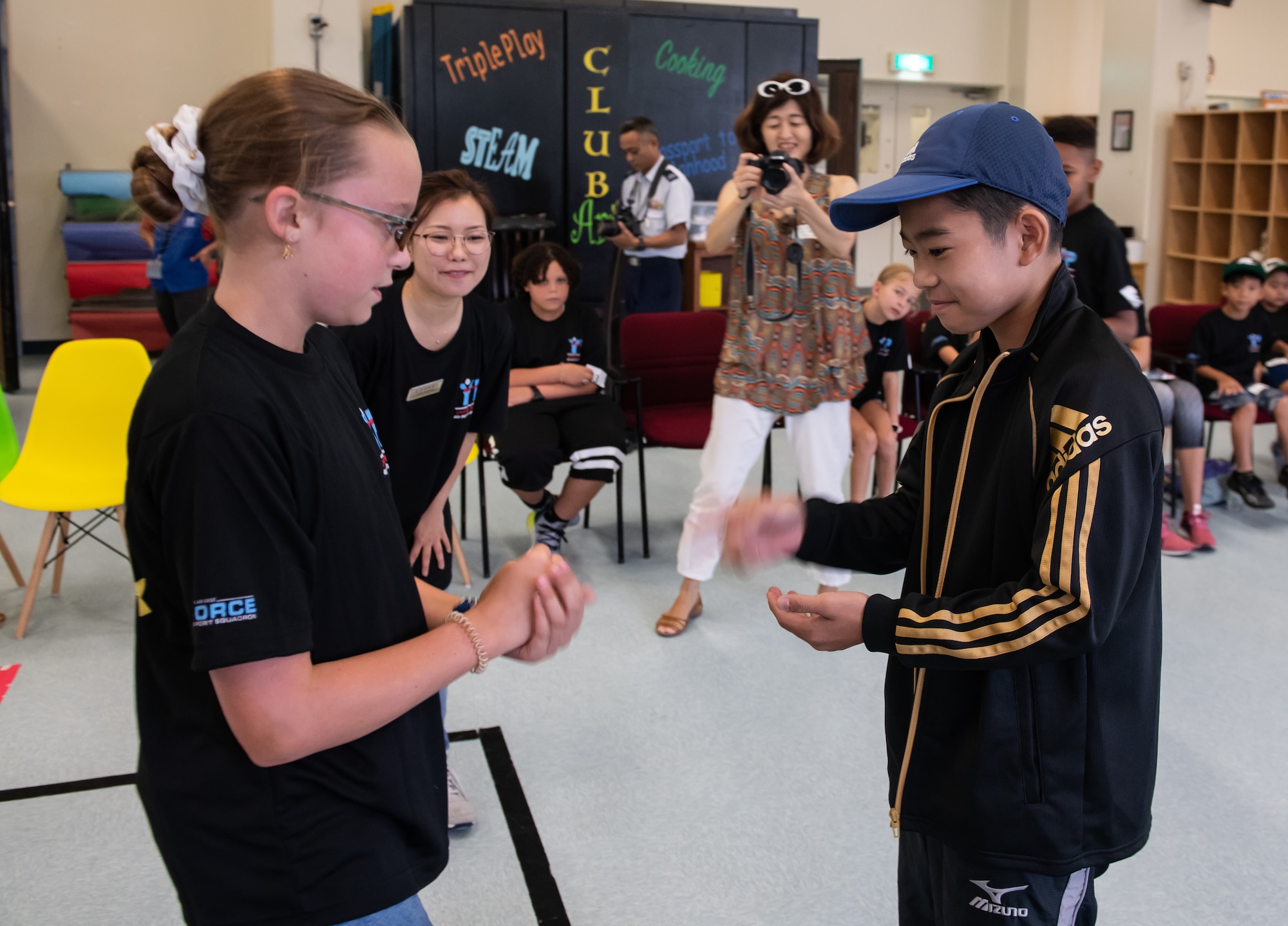 A child from the Kadena Youth Center and an Okinawan child compete in a Rock-Paper-Scissors Relay during Cultural Exchange Day, Sept. 28, 2019, at Kadena Air Base, Japan. The children were divided into six teams to play a variety of games, learn about each other’s culture and develop friendships. (U.S. Air Force photo by Staff Sgt. Micaiah Anthony)