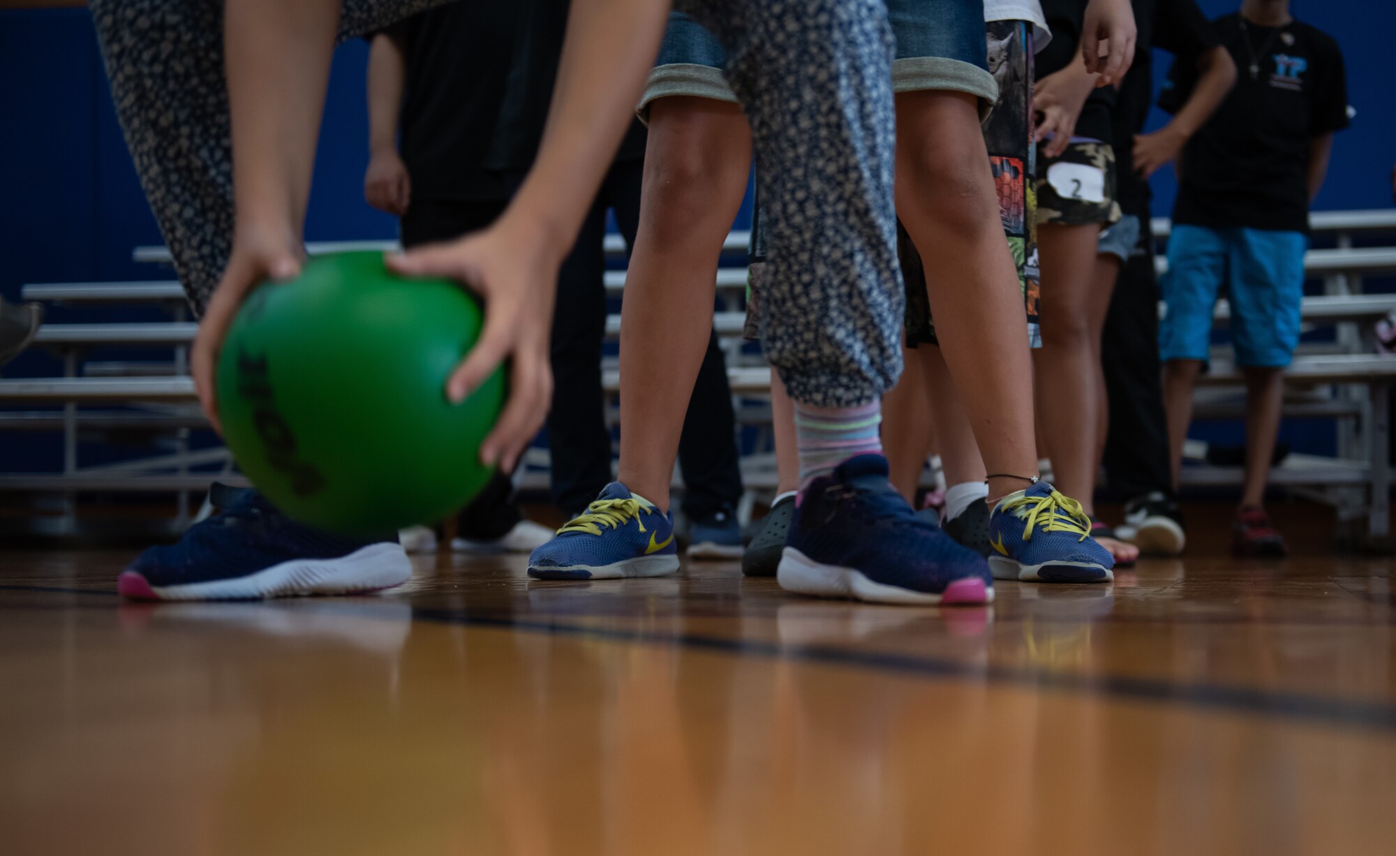 Children throw balls in a bucket as a part of a team building challenge during Cultural Exchange Day, Sept. 28, 2019, at Kadena Air Base, Japan. The children played a variety of games and challenges to learn about each other’s culture and develop friendships. (U.S. Air Force photo by Staff Sgt. Micaiah Anthony)