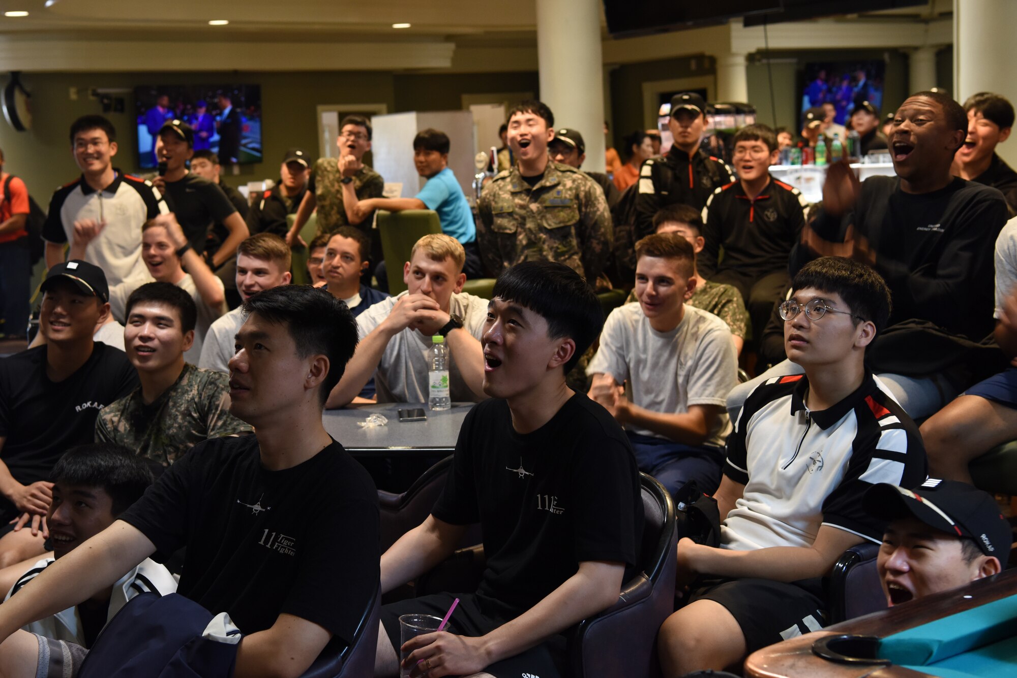 Airmen from the 8th Fighter Wing and 38th Fighter Group cheer on their teams during Friendship Day at Kunsan Air Base, Republic of Korea, Oct. 4, 2019. Friendship Day celebrates the partnership between the 8th FW and 38th FG, who participated in several sporting events and competitions throughout the day. (U.S. Air Force photo by Staff Sgt. Joshua Edwards)