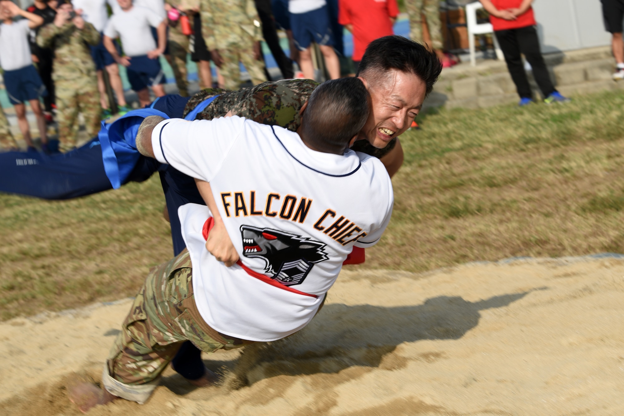 U.S. Air Force Chief Master Sgt. Craig Brodber, 8th Mission Support Group superintendent, and Republic of Korea Air Force Chief Master Sgt. Byung-ha Kim, 38th Fighter Group chief, compete with each other in Ssireum during Friendship Day at Kunsan Air Base, Republic of Korea, Oct. 4, 2019. Ssireum is a Korean folk wrestling style and is the traditional national sport of Korea. (U.S. Air Force photo by Staff Sgt. Joshua Edwards)