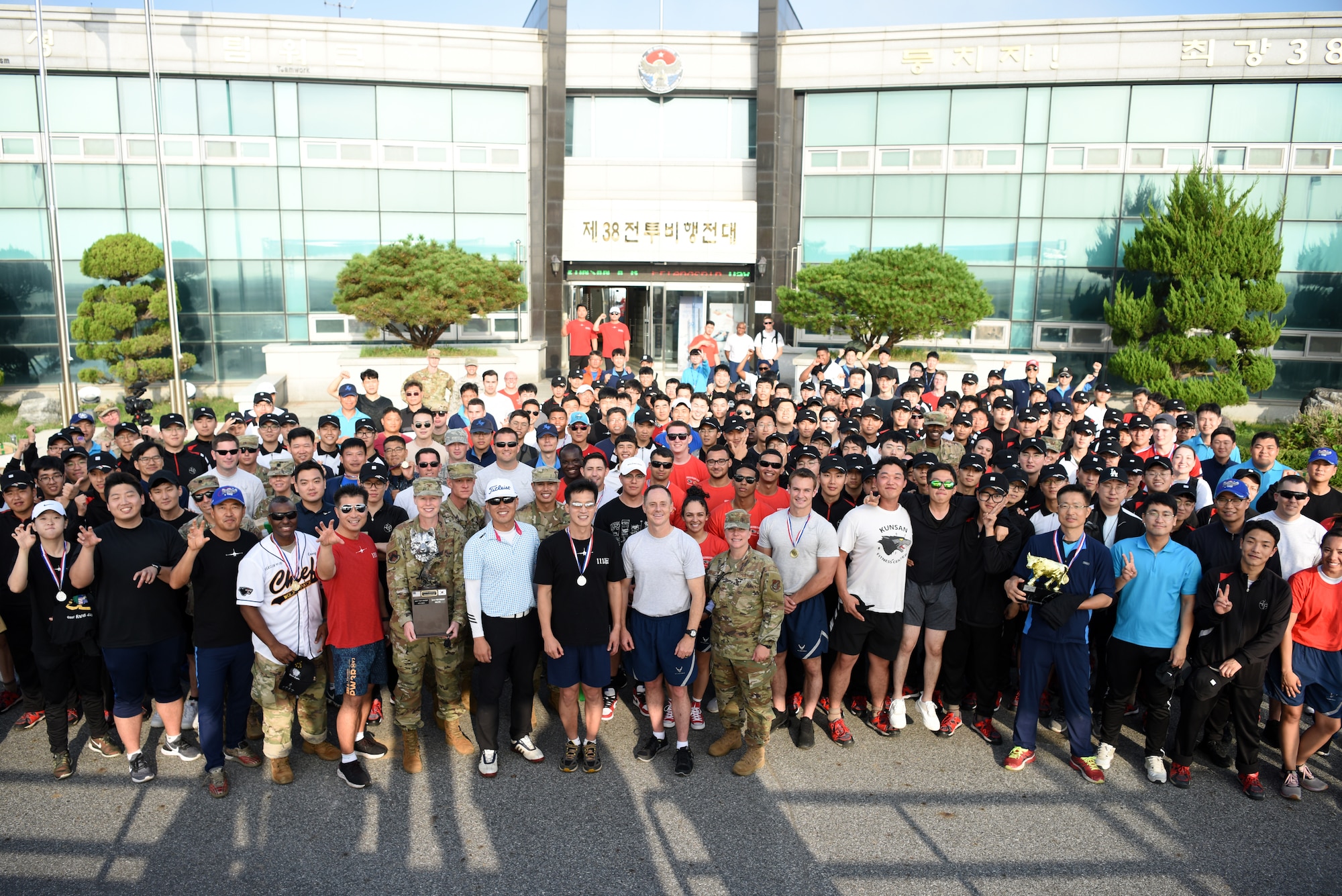 U.S. Air Force 8th Fighter Wing and Republic of Korea 38th Fighter Group members pose for a group photo at Kunsan Air Base, Republic of Korea, Oct. 4, 2019. Every year the 8th FW and 38th FG hold a joint Friendship Day to strengthen the alliance between service members. (U.S. Air Force photo by Staff Sgt. Joshua Edwards)