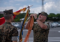 U.S. Marine Col. Michael J. Roach, Commanding Officer of 12th Marine Regiment, 3rd Marine Division, attaches a streamer to colors during the 12th Marine Regiment 92nd Anniversary Battle Colors Rededication Ceremony on Camp Hansen, Okinawa, Japan, Oct. 4, 2019. The ceremony is an opportunity for Marines to remember warriors past and to recognize contributions of service members and families to current operations. (U.S. Marine Corps photo by Lance Cpl. D’Angelo Yanez)