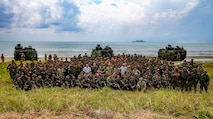 BLUE BEACH, Malaysia (Oct. 2, 2019) U.S. Marines and Sailors with 2nd Battalion, 2nd Marine Regiment, currently assigned to 3rd Marine Division, and members of the Malaysian Armed Forces (MAF), gather for a group photo after storming a beach during Tiger Strike 2019. Tiger Strike 19 focuses on strengthening joint military interoperability and on increasing readiness by practicing for humanitarian assistance, disaster relief, amphibious and jungle warfare operations, all while fostering cultural exchanges between the MAF and the U.S. Navy, Marine Corps team. (U.S. Marine Corps photo by Lance Cpl. Christine Phelps)