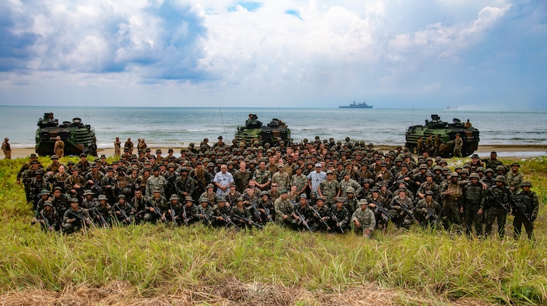 BLUE BEACH, Malaysia (Oct. 2, 2019) U.S. Marines and Sailors with 2nd Battalion, 2nd Marine Regiment, currently assigned to 3rd Marine Division, and members of the Malaysian Armed Forces (MAF), gather for a group photo after storming a beach during Tiger Strike 2019. Tiger Strike 19 focuses on strengthening joint military interoperability and on increasing readiness by practicing for humanitarian assistance, disaster relief, amphibious and jungle warfare operations, all while fostering cultural exchanges between the MAF and the U.S. Navy, Marine Corps team. (U.S. Marine Corps photo by Lance Cpl. Christine Phelps)