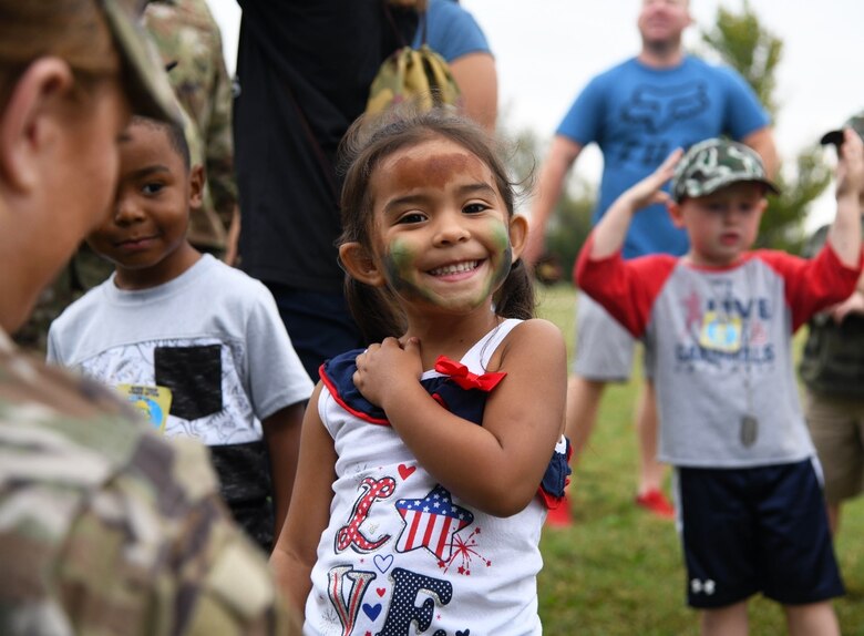Destiny Jamieson age 4, smiles after her face is painted during the family mobility line event Sept. 28, 2019 at McConnell Air Force Base, Kan. After receiving a pre-deployment briefing covering topics such as deployment safety, required immunizations and other available resources, each child was issued a mobility bag, camouflage hat and their own set of dog tags.  (U.S. Air Force photo by Airman 1st Class Nilsa E. Garcia)