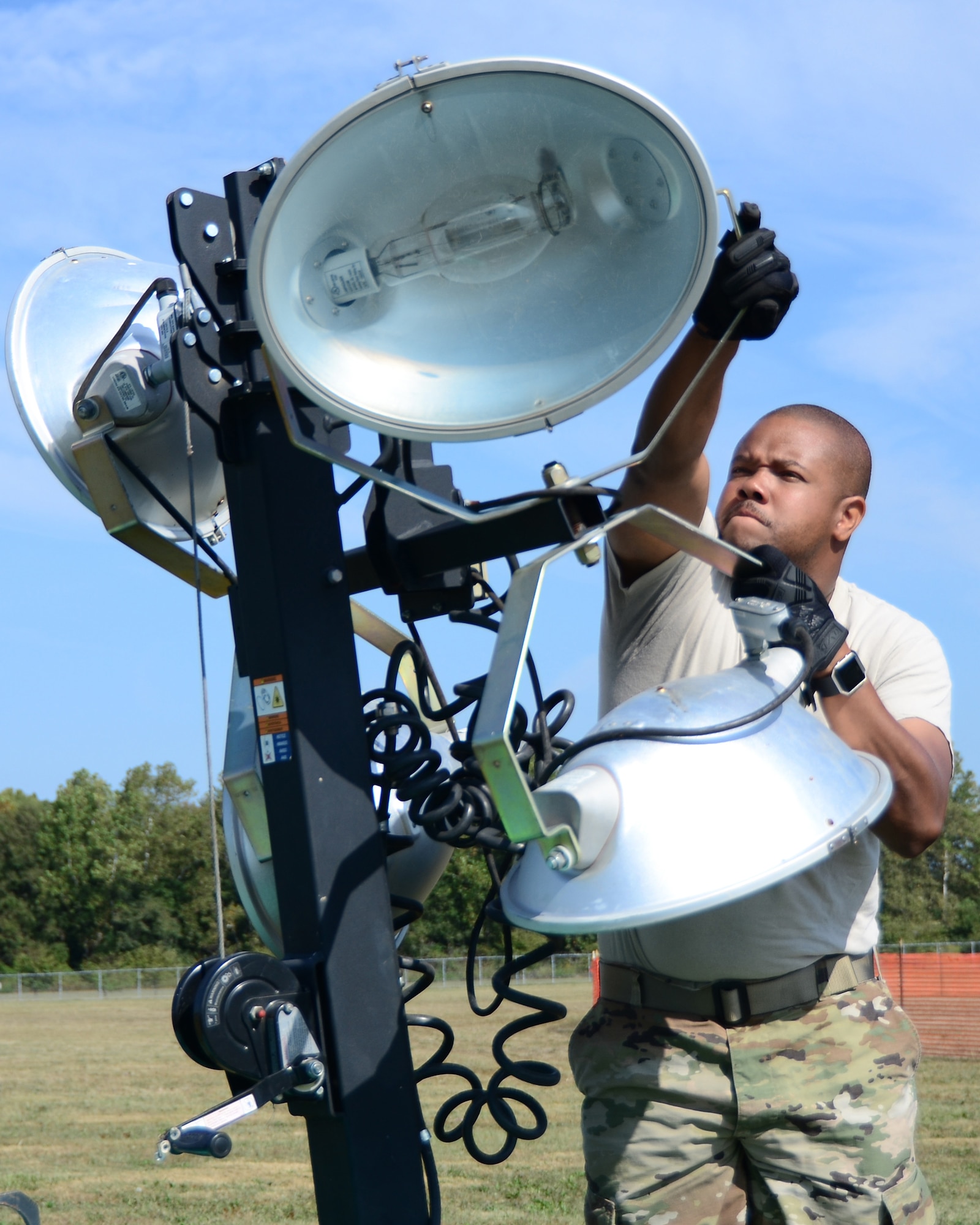 Master Sgt. Antoinn Kidd, 445th Logistics Readiness Squadron, sets up a portable lights tower in an open field of the National Museum of the United States Air Force, Sept. 19, 2019. Kidd and other 445th LRS members provided support for the 2019 Air Force Marathon.