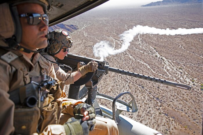 U.S. Marine Corps Cpl. Ross Roby, right, a UH-1Y Venom crew chief, with Marine Light Attack Helicopter Squadron 367, Marine Aircraft Group 39, 3rd Marine Aircraft Wing, engages targets while conducting an offensive air support exercise during Weapons and Tactics Instructor course 1-20 at Chocolate Mountain Aerial Gunnery Range, California, Sept. 30, 2019. WTI is a seven-week training event hosted by Marine Aviation Weapons and Tactics Squadron One, which emphasizes operational integration of the six functions of Marine Corps aviation in support of a Marine Air Ground Task Force. WTI also provides standardized advanced tactical training and certification of unit instructor qualifications to support Marine aviation training and readiness, and assists in developing and employing aviation weapons and tactics.