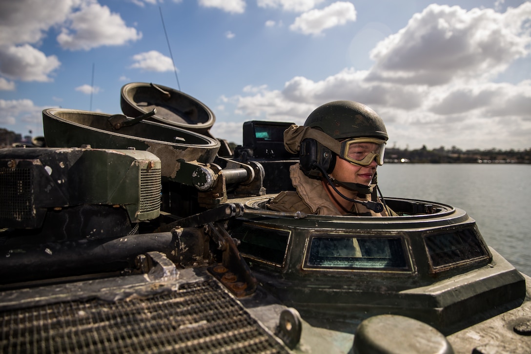 U.S. Marine Pfc. Wyatt Fender, a student with Assault Amphibian School Battalion, Training Command, conducts a communications check in an AAV-P7/A1 Amphibious Assault Vehicle prior to basic water and amphibious operations at the 21 Area boat basin on Marine Corps Base Camp Pendleton, California, Oct. 1, 2019. This training is meant to teach students basic amphibious operations like going to and from shore. The mission of the battalion is to teach Marines in Amphibious Assault Vehicle operations and maintenance while assisting in the development of formal training and logistical evaluations of new AAV systems. Fender is a native of Valdosta, Georgia.