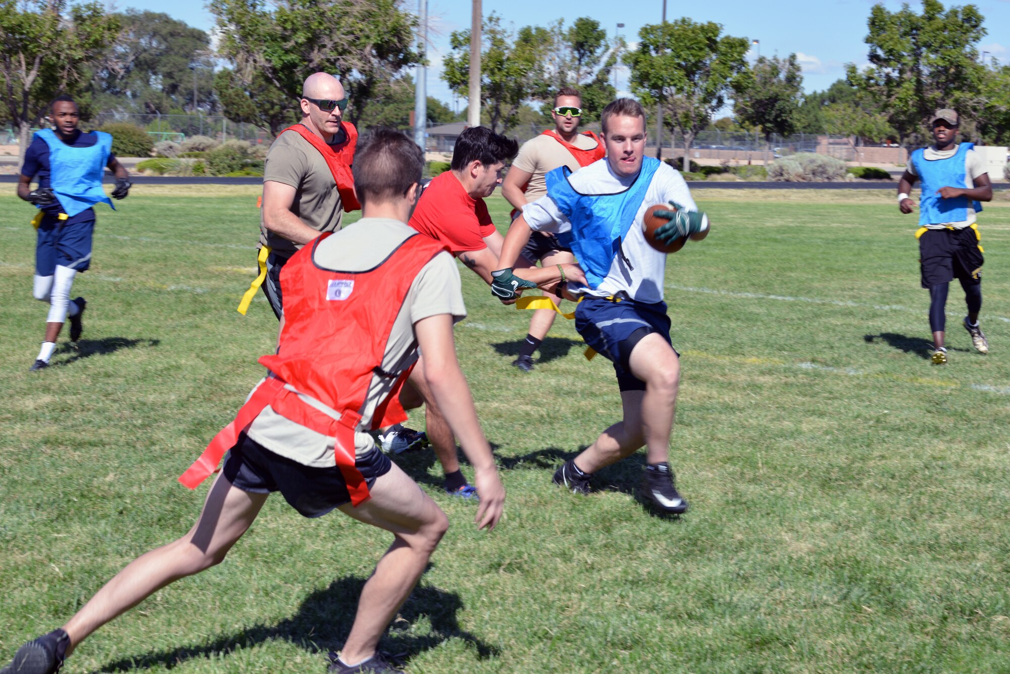 Members of the 58th Special Operations Wing play flag football during the 2019 58 SOW Sports Day at Kirtland Air Force Base, N.M., Sept. 27, 2019. Other sports played throughout the day included basketball, kickball, volleyball and more. The sports day included a competition between all the squadrons in the wing with top placements in every sport earning points for the unit. The 58th Aircraft Maintenance Squadron won the competition with almost double the points of the second place squadron.