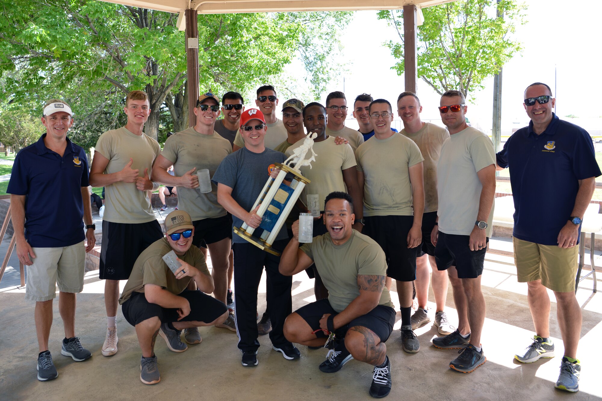 Members of the 58th Aircraft Maintenance Squadron pose for a group photo with 58th Special Operations Wing leadership after being presented the 2019 Wing Sports Day trophy at Kirtland Air Force Base, N.M., Sept. 27, 2019. The sports day included a competition between all the squadrons in the wing with top placements in every sport earning points for the unit. The 58th Aircraft Maintenance Squadron won the competition with almost double the points of the second place squadron.