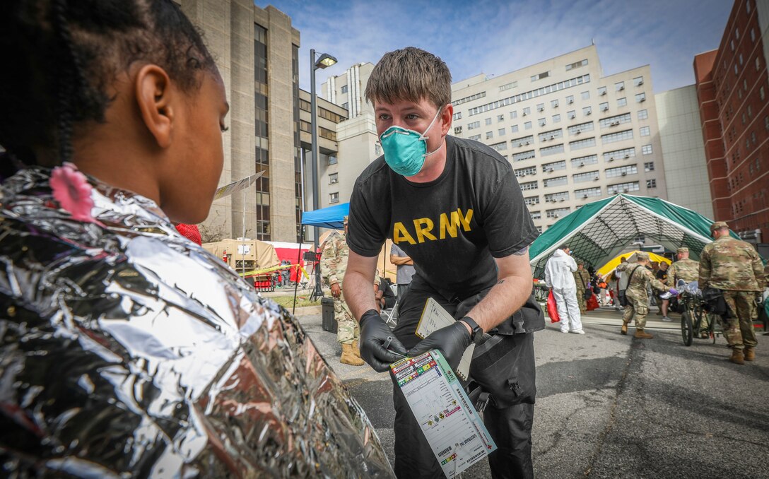 Army Reserve Spc. Dylan Gibbons, a combat medic and native of Amesbury, Massachusetts, assigned to the 456th Medical Company (Area Support), processes a young girl through a medical treatment area during a mass casualty decontamination event at the Jacobi Medical Center, Bronx, New York, Sept. 28. The event, involving nearly 150 Army Reserve Soldiers, was part of a two-day consequence management training exercise focused on mass casualty decontamination, Chemical, Biological, Radiological and Nuclear (CBRN) reconnaissance and medical operations along side multiple civilian agencies in and around New York City. The training involved various scenarios including rescuing patients from a Subway disaster and decontamination operations at a local hospital. (Official U.S. Army Reserve photo by Sgt. 1st Class Brent C. Powell)