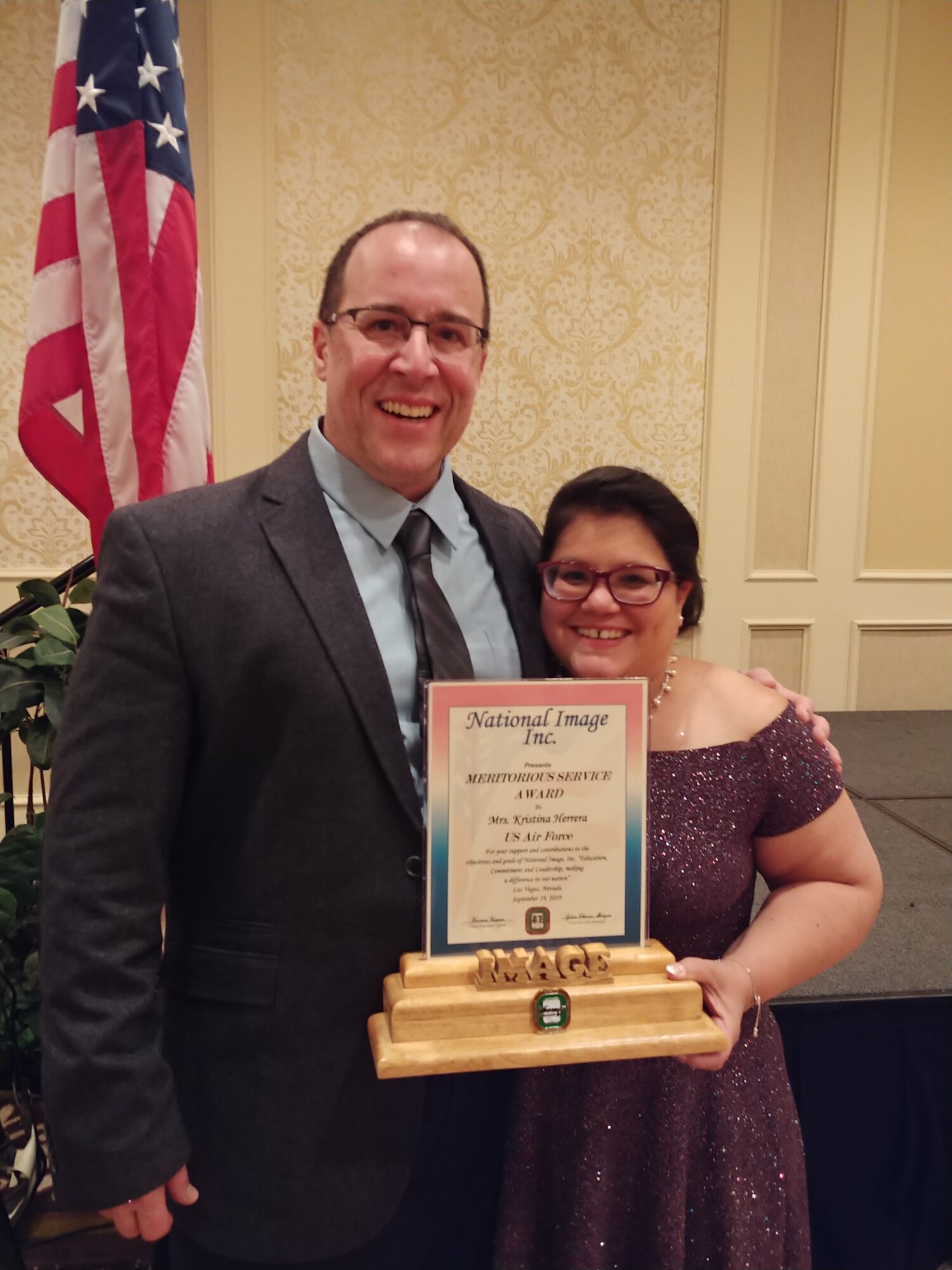 Kristine Herrera poses with her spouse, retired Air Force Master Sgt. Gustavo Herrera, shortly after receiving the National Image Inc. 2019 Meritorious Service Award . (Photo courtesy of Kristine Herrera)