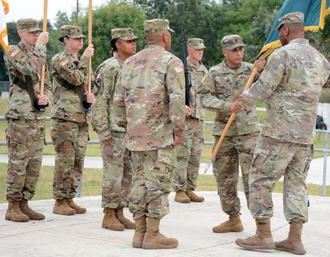 Command Sgt. Maj. Christopher Earle accepts the unit colors from Maj. Gen. Patrick D. Sargent, becoming the 15t MEDCoE NCOA Commandant.