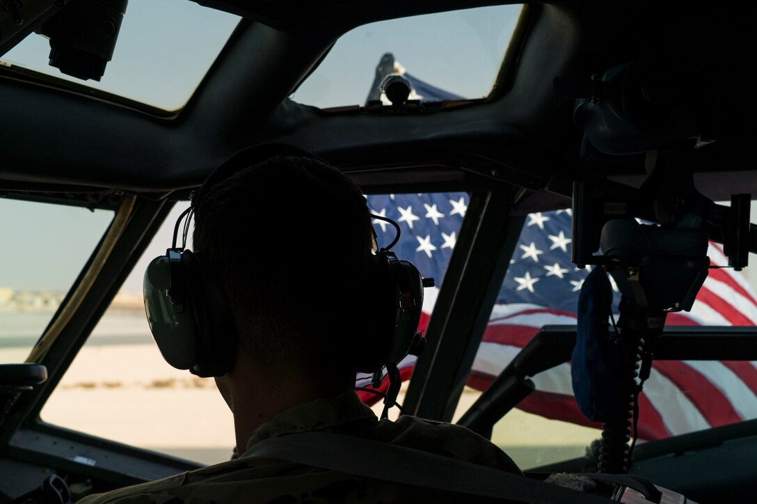Pilot flies an American flag outside of an aircraft