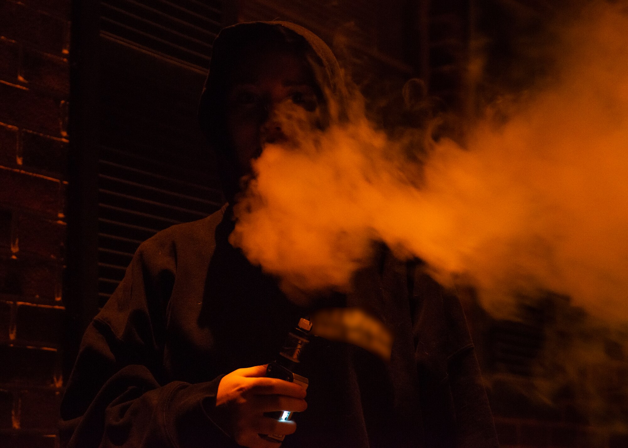 An Airman blows vapor into the air at Warrensburg, MO, Oct. 2, 2019. According to the Centers for Disease Control and Prevention, e-cigarettes produce an aerosol by heating a liquid mixture of nicotine, flavorings or other chemicals which users then inhale. Members should learn the risks they take when choosing to vape and they’re encouraged to use the 509th Medical Group’s resources for quitting smoking or vaping. (U.S. Air Force photo by Staff Sgt. Sadie Colbert)
