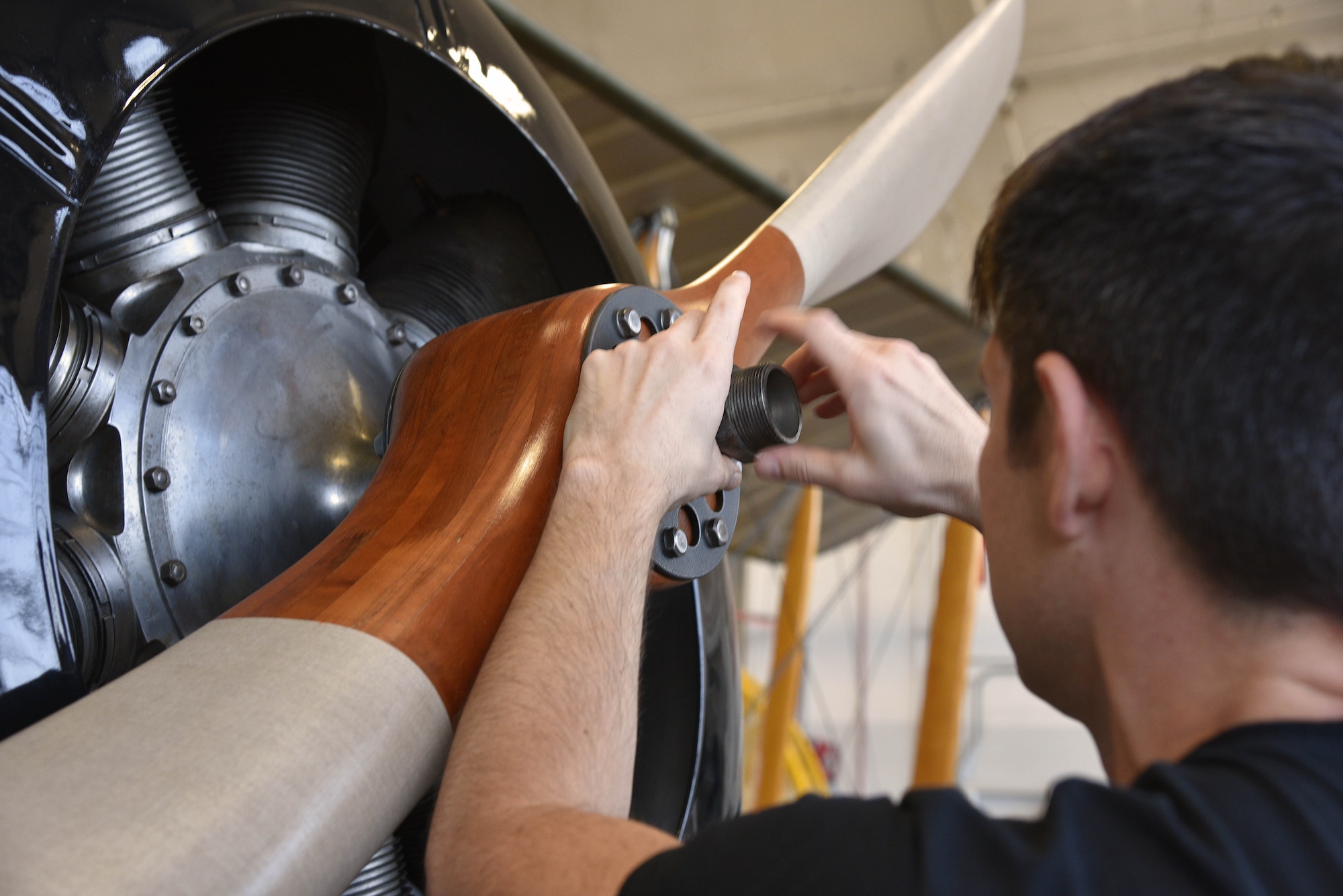 Propeller of a biplane being installed during restoration.