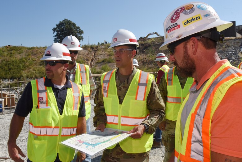 Jody Robinson (Left), Nashville District mechanical engineer with the Kentucky Lock Addition Project in Grand Rivers, Ky., updates Maj. Gen. Robert F. Whittle, U.S. Army Corps of Engineers Great Lakes and Ohio River Division commanding general, on construction of the downstream coffer dam with concrete shells that will also be part of the permanent lock wall. (USACE photo by Lee Roberts)