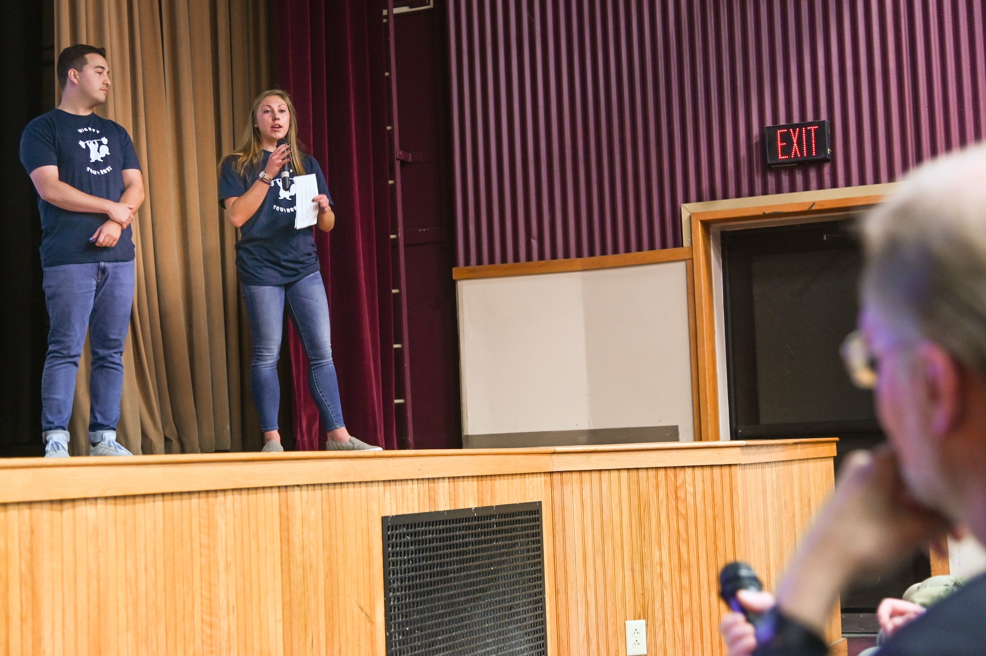 Allie Townsend, contract specialist for the Distributed Common Ground System and Extended Tether Program, speaks to Steve Wert, program executive officer for Digital, while Victor Kogan, logistics management specialist in the Space, Aerial & Nuclear Networks Division, looks on during the Pitch-IN event held at the base theater, Hanscom Air Force Base, Mass., Oct. 2.