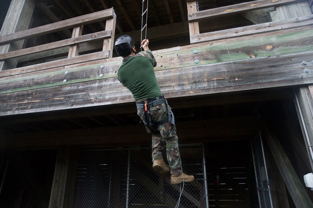 A Marine Raider climbs a ladder during the annual Marine Forces Special Operations Command 2019 Marine Raider Competition on Marine Corps Base Camp Lejeune, N.C., June 12, 2019. The competition fostered camaraderie and tested participants’ operational capabilities consistent with special operations missions through a rigorous evolution of events and to honor Marine Raider heritage.  The competition consisted of six teams of six participants hailing from 1st Marine Raider Battalion, 2nd Marine Raider Battalion, 3rd Marine Raider Battalion, Marine Raider Training Center and 2nd Marine Reconnaissance Battalion. (U.S. Marine Corps photo by Lance Cpl. Michael Neunehoff)