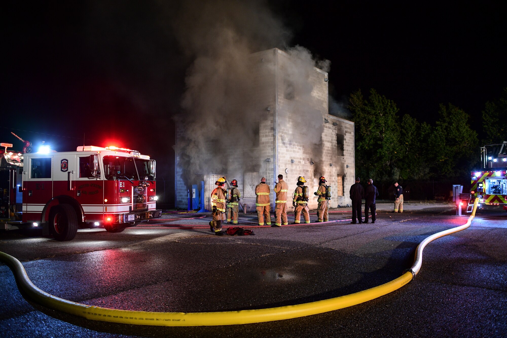 Base firefighters battle a structural fire Oct. 1, 2019, at Hill Air Force Base, Utah. The fire was part of a Hill AFB Fire and Emergency Services training demonstration to showcase the capability of a new, 100-foot ladder truck the department acquired this summer. (U.S. Air Force photo by R. Nial Bradshaw)