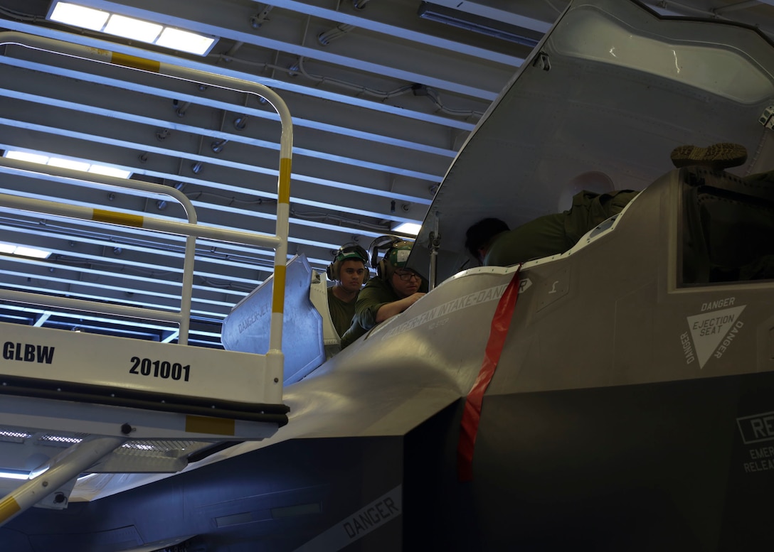 U.S. Marines with Marine Fighter Attack Squadron (VMFA) 122, Marine Aircraft Group (MAG) 13, 3rd Marine Aircraft Wing (MAW), perform maintenance on an F-35B Lightning II aboard the amphibious assault ship USS America (LHA 6) in the Eastern Pacific, Sept. 30, 2019. Operating safe aircraft requires a team effort and constant training to allow air crews to enhance their aviation skills in preparation for combat. (U.S. Marine Corps photo by Lance Cpl. Juan Anaya)