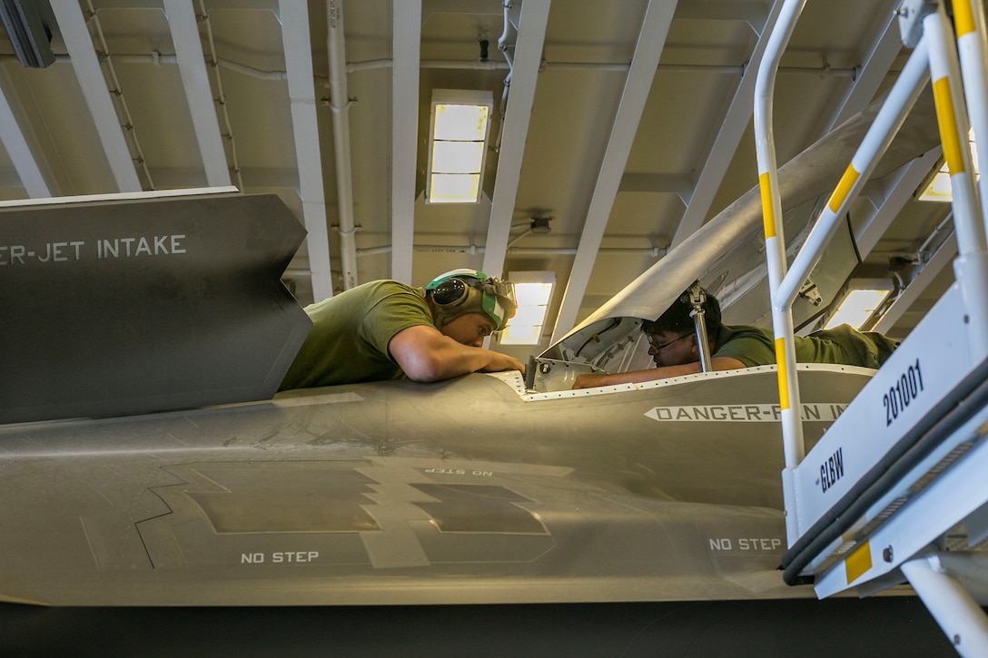 U.S. Marines with Marine Fighter Attack Squadron (VMFA) 122, Marine Aircraft Group (MAG) 13, 3rd Marine Aircraft Wing (MAW), perform maintenance on an F-35B Lightning II aboard the amphibious assault ship USS America (LHA 6) in the Eastern Pacific, Sept. 30, 2019. Operating safe aircraft requires a team effort and constant training to allow air crews to enhance their aviation skills in preparation for combat. (U.S. Marine Corps photo by Lance Cpl. Juan Anaya)
