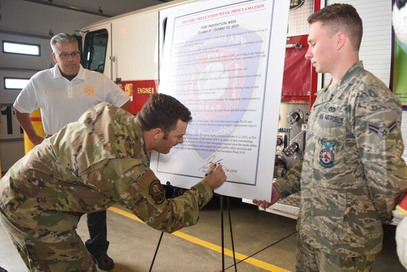 Lt. Col. Jacob Leck, 22nd Civil Engineering Squadron commander, signs the 2019 Fire Prevention Week Proclamation Oct. 4, 2019, at McConnell Air Force Base, Kan.  During fire prevention week, McConnell AFB Fire Department hosts various activities in order to raise fire safety awareness for Airmen and their families. (U.S. Air Force photo by Airman 1st Class Alexi Bosarge)