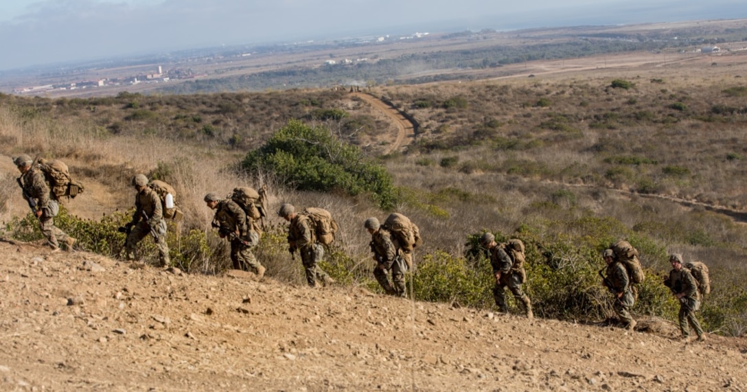U.S. Marines with Charlie Company, 1st Battalion, 5th Marine Regiment, 1st Marine Division, hike up a hill during the Marine Corps Combat Readiness Evaluation (MCCRE) on Marine Corps Base Camp Pendleton, California, Sept. 23, 2019. 5th Marines conducted a regimental-sized MCCRE for 1st Battalion, 5th Marines and 2nd Battalion, 5th Marines, as well as the Regimental Headquarters to increase the combat proficiency and readiness of the regiment. The MCCRE took place over a 10 day period and served as proof of concept for future regimental-sized MCCREs. (U.S. Marine Corps photo by Lance Cpl. Alexa M. Hernandez)
