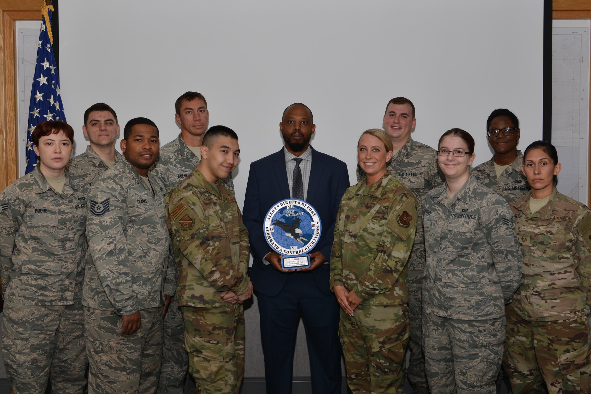 The 377th Air Base Wing Command Post pose for a photo at Kirtland Air Force Base, N.M., Sept. 24, 2019. The CP is responsible for maintaining a responsive and reliable 24-hour command and control system, linking higher command and control centers with local senior leaders, local operational and support agencies, and the base populace. The 377th ABW Command Post was named the 2018 Large Command Post of the Year. (Portions of this image have been blurred to protect operational security.) (U.S. Air Force photo by Staff Sgt. Dylan Nuckolls)