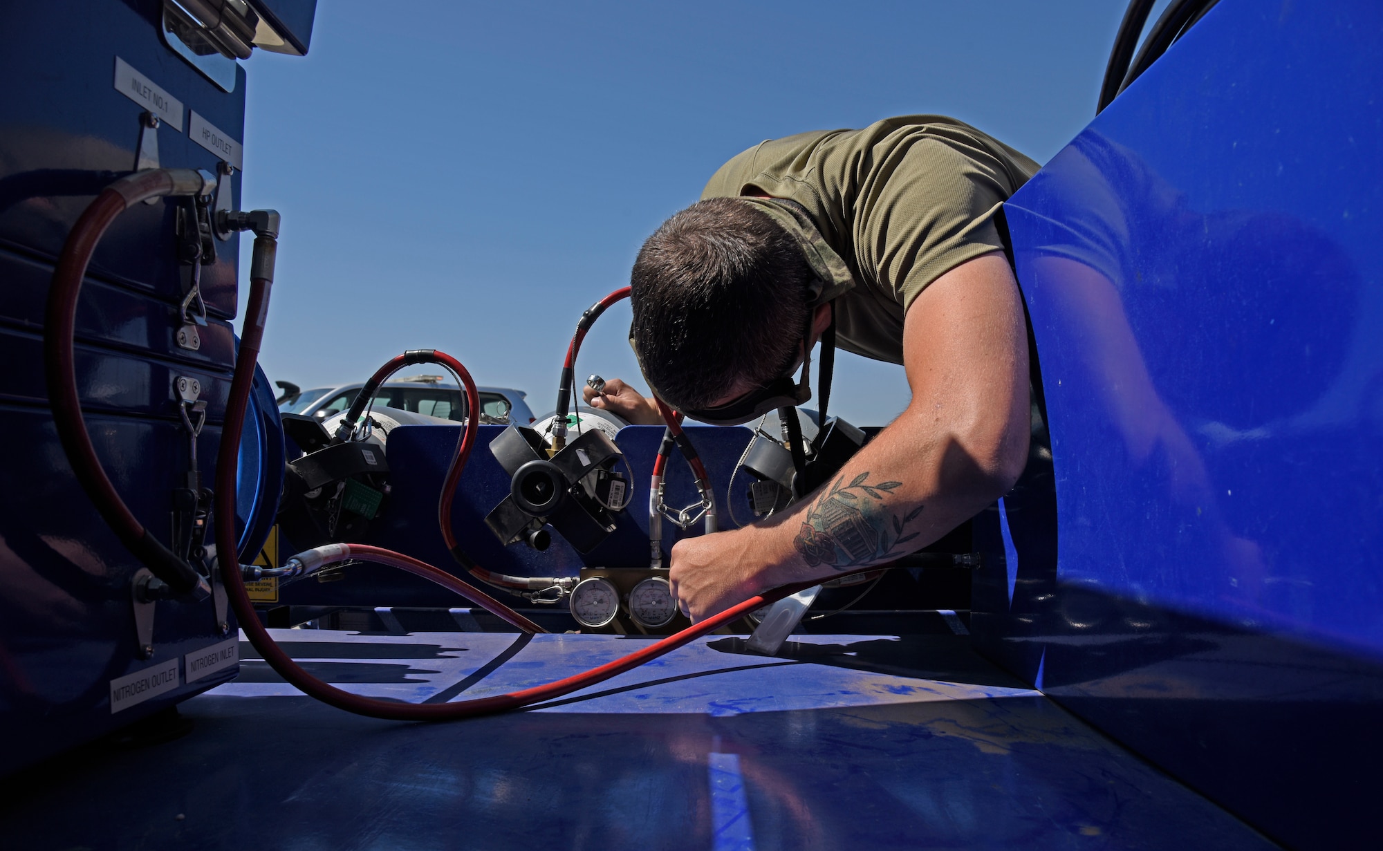 U.S. Air Force Staff Sgt. Robert Hunter, 92nd Aircraft Maintenance Squadron flying crew chief, checks nitrogen pressurization at Royal Australian Air Force Amberley, Australia, Sept. 15, 2019. Air Mobility Command averages one aircraft departure every 2.9 minutes, and the 618th Air Operations Center executes command and control over 200 of those sorties every day. (U.S. Air Force photo by Senior Airman Jesenia Landaverde)