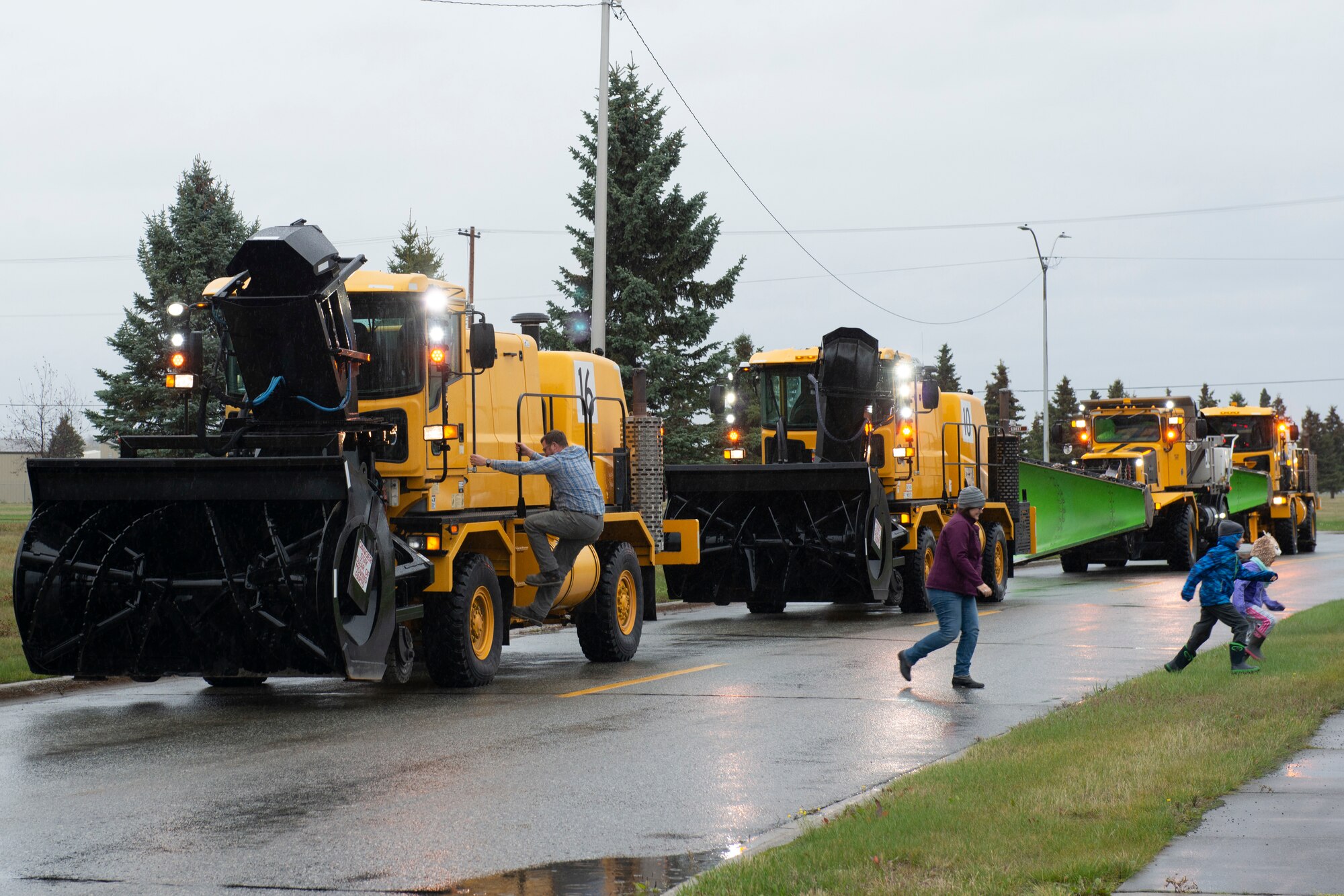 Spectators watch the 773rd Civil Engineer Squadron’s annual Snow & Ice Parade at Joint Base Elmendorf-Richardson, Alaska, Oct. 4, 2019. The parade showcased the snow-removal vehicles snow barn personnel use to keep the airfield operational and the roads cleared.