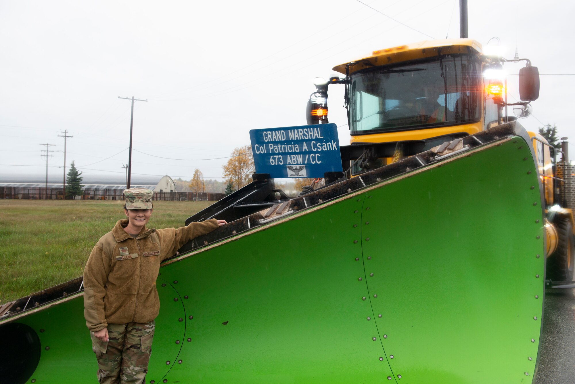 U.S. Air Force Col. Patricia Csànk, Joint Base Elmendorf-Richardson and 673d Air Base Wing commander, poses for a photo before grand marshaling the 773rd Civil Engineer Squadron’s annual Snow & Ice Parade at Joint Base Elmendorf-Richardson, Alaska, Oct. 4, 2019. The parade showcased the snow-removal vehicles snow barn personnel use to keep the airfield operational and the roads cleared.