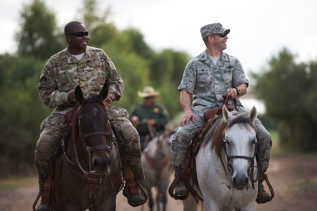 Col. Lee Gentile, 47th Flying Training Wing commander, and Command Chief Master Sgt. Robert Zackery III, 47th FTW command chief ride horseback along the U.S.-Mexico border in Del Rio, Texas Oct. 4, 2019. Del Rio Border Patrol Sector officials invited Laughlin leadership on a tour of operations and a goal to build partnership between the two local agencies. (U.S. Air Force photo by Senior Airman Marco A. Gomez)