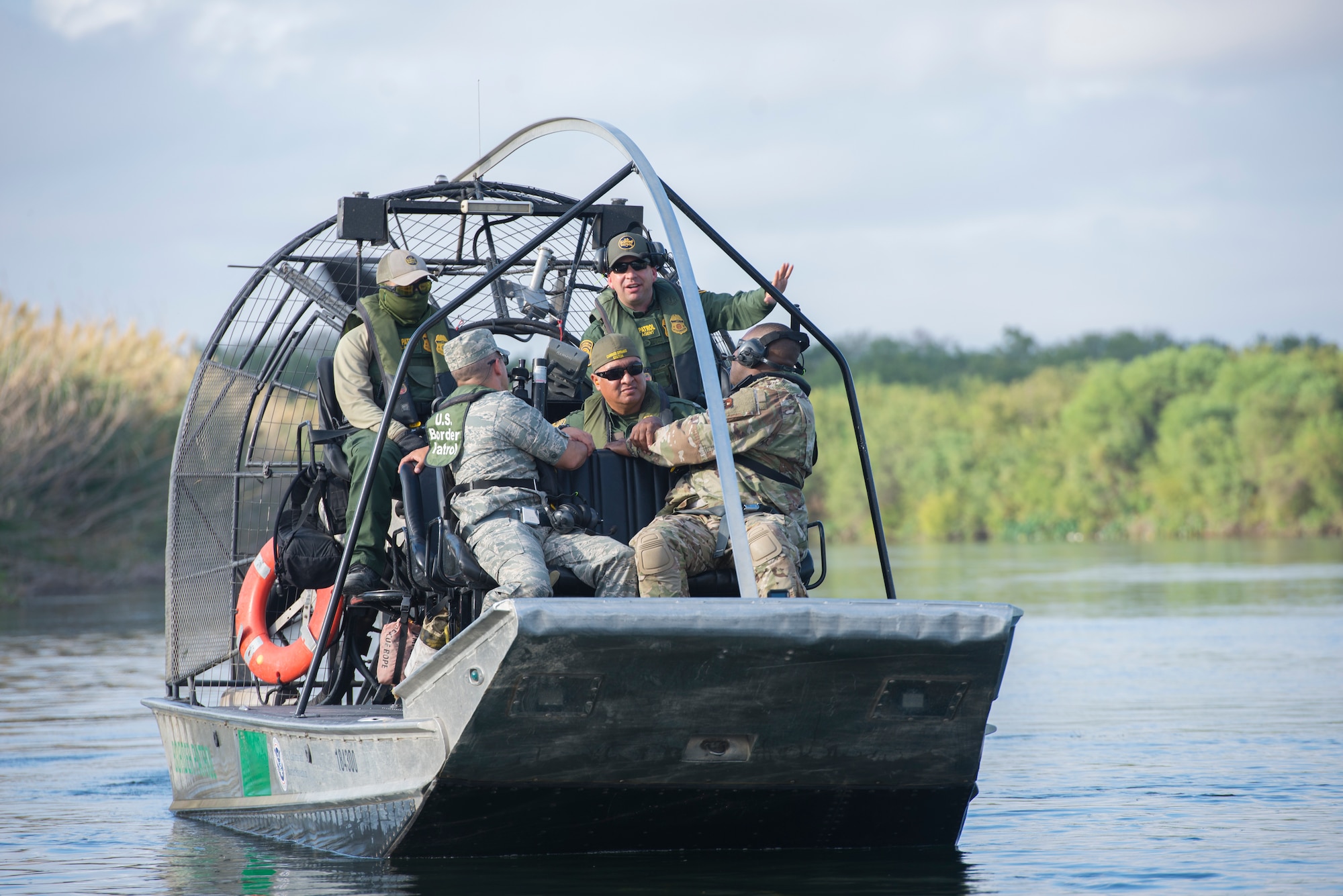 A U.S. Border Patrol vessel commander talks with Col. Lee Gentile, 47th Flying Training Wing commander and Command Chief Master Sgt. Robert Zackery III, 47th FTW command chief, during a Border Patrol immersion tour in Del Rio, Texas, Oct. 4, 2019. The command team got a tour with Del Rio Border Patrol Sector on the Rio Grande river, which marks a portion of the international border between the U.S. and Mexico. (U.S. Air Force photo by Senior Airman Marco A. Gomez)