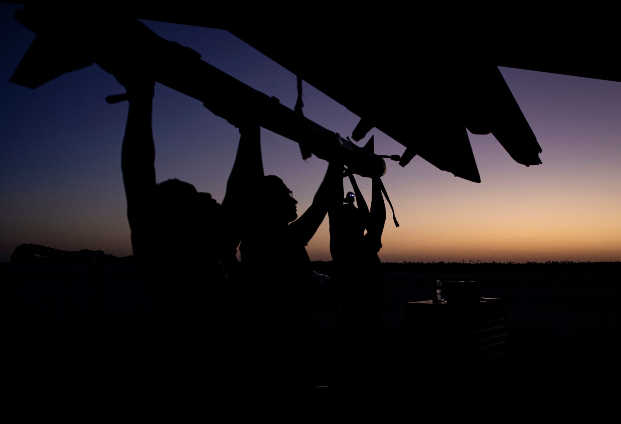 Three aircraft armament systems technicians assigned to the 757th Aircraft Maintenance Squadron, load an AIM-9X Sidewinder missile onto an F-15E Strike Eagle fighter jet during Combat Archer 19-12 at Tyndall Air Force Base, Fla., Sept. 24, 2019. The AIM-9X is a technologically advanced version of its predecessor, the AIM-9. (U.S. Air Force photo by Airman 1st Class Bailee A. Darbasie)