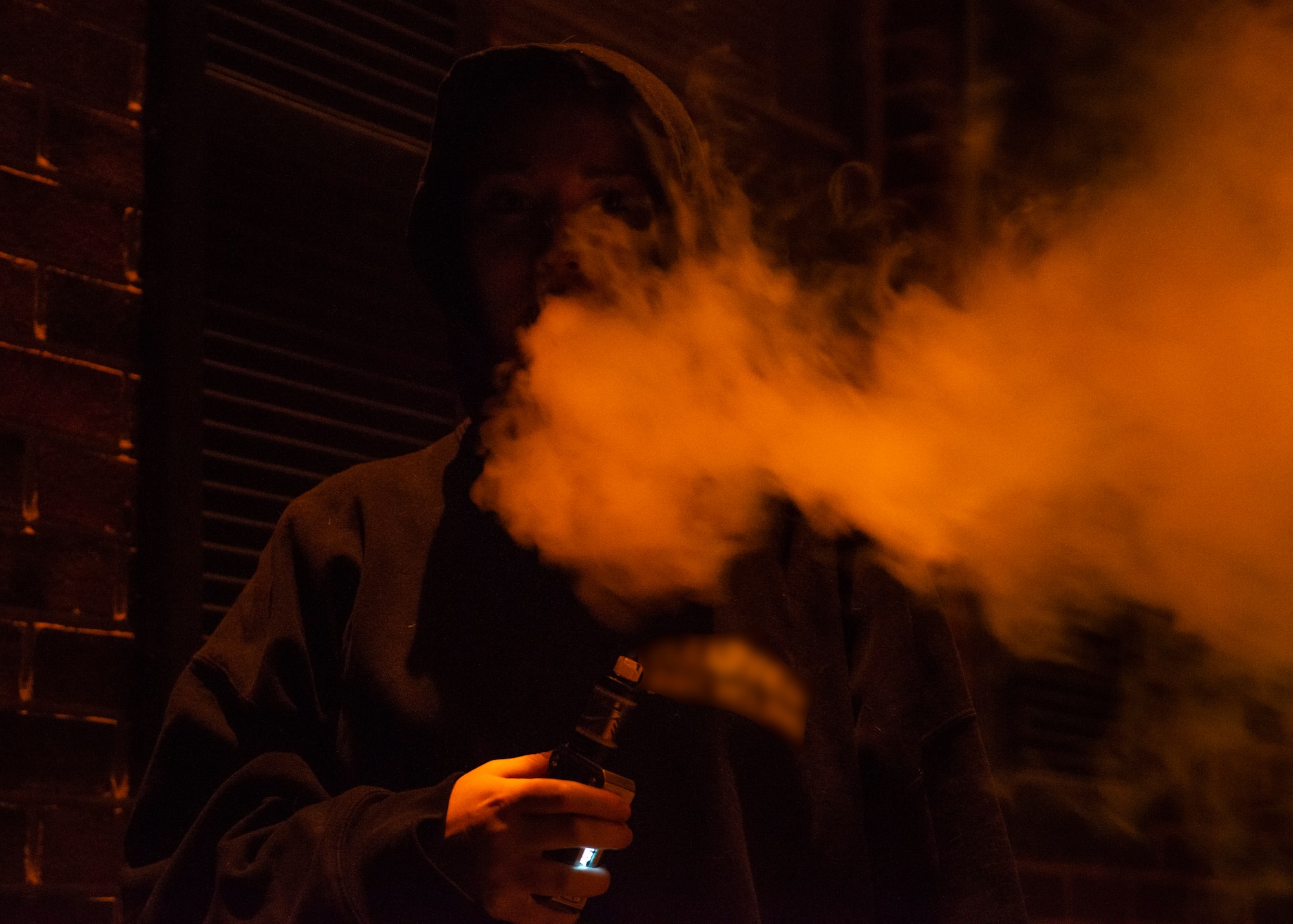 An Airman blows vapor into the air at Warrensburg, MO, Oct. 2, 2019. According to the Centers for Disease Control and Prevention, e-cigarettes produce an aerosol by heating a liquid mixture of nicotine, flavorings or other chemicals which users then inhale. Members should learn the risks they take when choosing to vape and they’re encouraged to use the 509th Medical Group’s resources for quitting smoking or vaping. (U.S. Air Force photo by Staff Sgt. Sadie Colbert)
