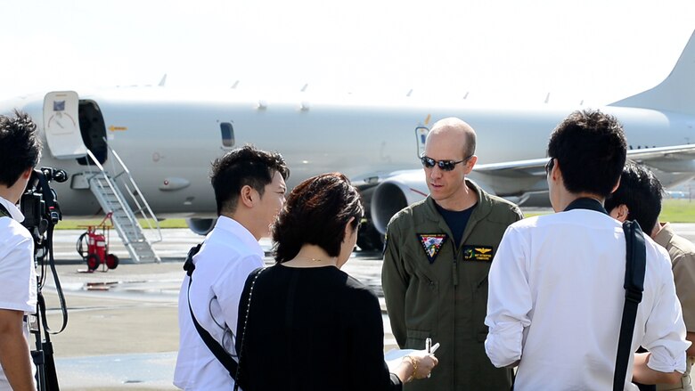 NAVAL AIR FACILITY ATSUGI, Japan (Oct.04, 2019) Captain Matthew F. Rutherford, commodore, Task Force 72, speaks with members of the Japanese media while standing near a U.S. Navy P-8A Poseidon aircraft from the “Mad Foxes” of Patrol Squadron (VP) 5. The VP-5 detachment participated in exercise Malabar 2019, and is conducting maritime patrol and reconnaissance as well as theater outreach operations within U.S. 7th Fleet area of operations.