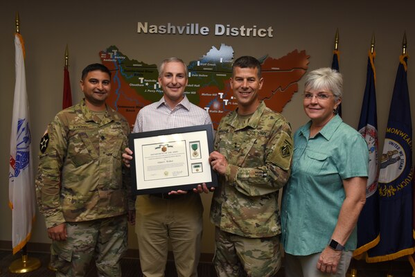 (Left to right) Lt. Col. Sonny B. Avichal, U.S. Army Corps of Engineers Nashville District commander; Adam Walker, Chickamauga Lock Replacement Project manager; Maj. Gen. Robert F. Whittle Jr., USACE Great Lakes and Ohio River Division commanding general; and Patty Coffey, Nashville District deputy district engineer; pose during an award ceremony Oct. 2, 2019 at the Nashville District Headquarters in Nashville, Tenn. Whittle presented Walker with the U.S. Army Civilian Service Commendation Medal for managing the Joint Risk Register Pilot Program, an effort to reduce safety risk and identify opportunities for improvement. (USACE photo by Lee Roberts)