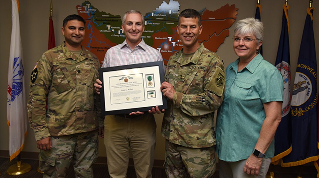(Left to right) Lt. Col. Sonny B. Avichal, U.S. Army Corps of Engineers Nashville District commander; Adam Walker, Chickamauga Lock Replacement Project manager; Maj. Gen. Robert F. Whittle Jr., USACE Great Lakes and Ohio River Division commanding general; and Patty Coffey, Nashville District deputy district engineer; pose during an award ceremony Oct. 2, 2019 at the Nashville District Headquarters in Nashville, Tenn. Whittle presented Walker with the U.S. Army Civilian Service Commendation Medal for managing the Joint Risk Register Pilot Program, an effort to reduce safety risk and identify opportunities for improvement. (USACE photo by Lee Roberts)