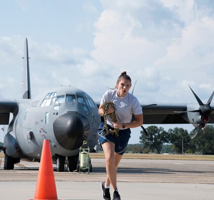 Master Sgt. Danielle Allaire, 41st Aerial Port Squadron non-commissioned officer in charge of passenger services, participates in the "fit to fight" portion of the 2019 Port Dawg Challenge at Keesler Air Force Base, Miss., Oct. 5. The fitness portion was a relay style event that required each participant to carry chains to one end of the course, do burpees or push-ups, and run back. (U.S. Air Force photo by Senior Airman Kristen Pittman).