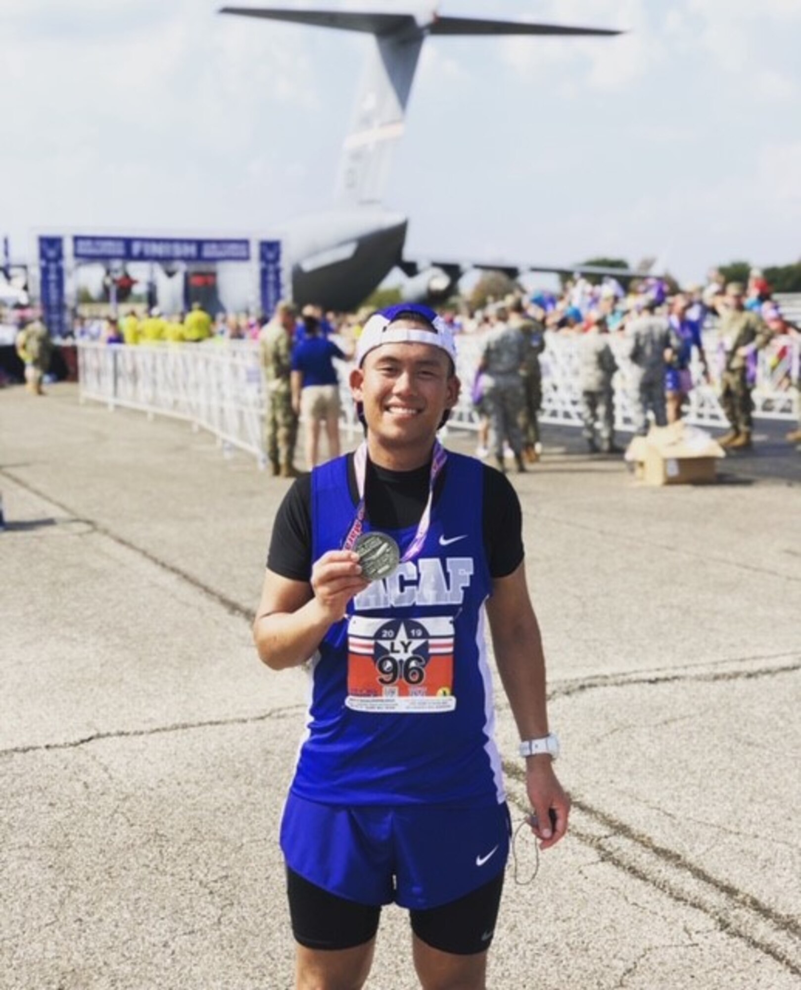 U.S. Air Force Staff Sgt. Daniel Ly, 8th Force Support Squadron customer support noncommissioned officer in charge, poses with his medal after completing the Air Force Marathon at Wright-Patterson Air Force Base, Ohio, Sept. 21, 2019. Ly has been running since 8th grade and has competed in 17 full marathon races. (Courtesy photo)