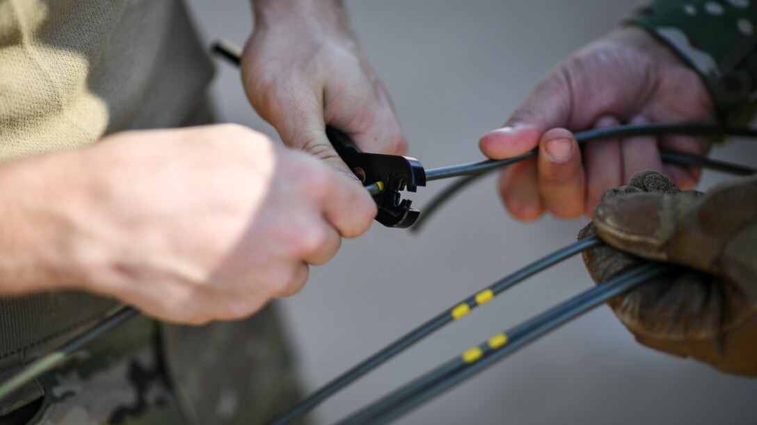 Airmen assigned to the 386th Expeditionary Civil Engineer Squadron explosive ordnance disposal flight at Ali Al Salem Air Base, cut a  fuse cord before a rapid airfield damage repair exercise at Udari Range, Kuwait, Sept. 25, 2019. The fuse cord is a non-electronic means to detonate explosives. When lit the fuse cord burns slowly until it reaches the blasting cap to set off the explosive charge.