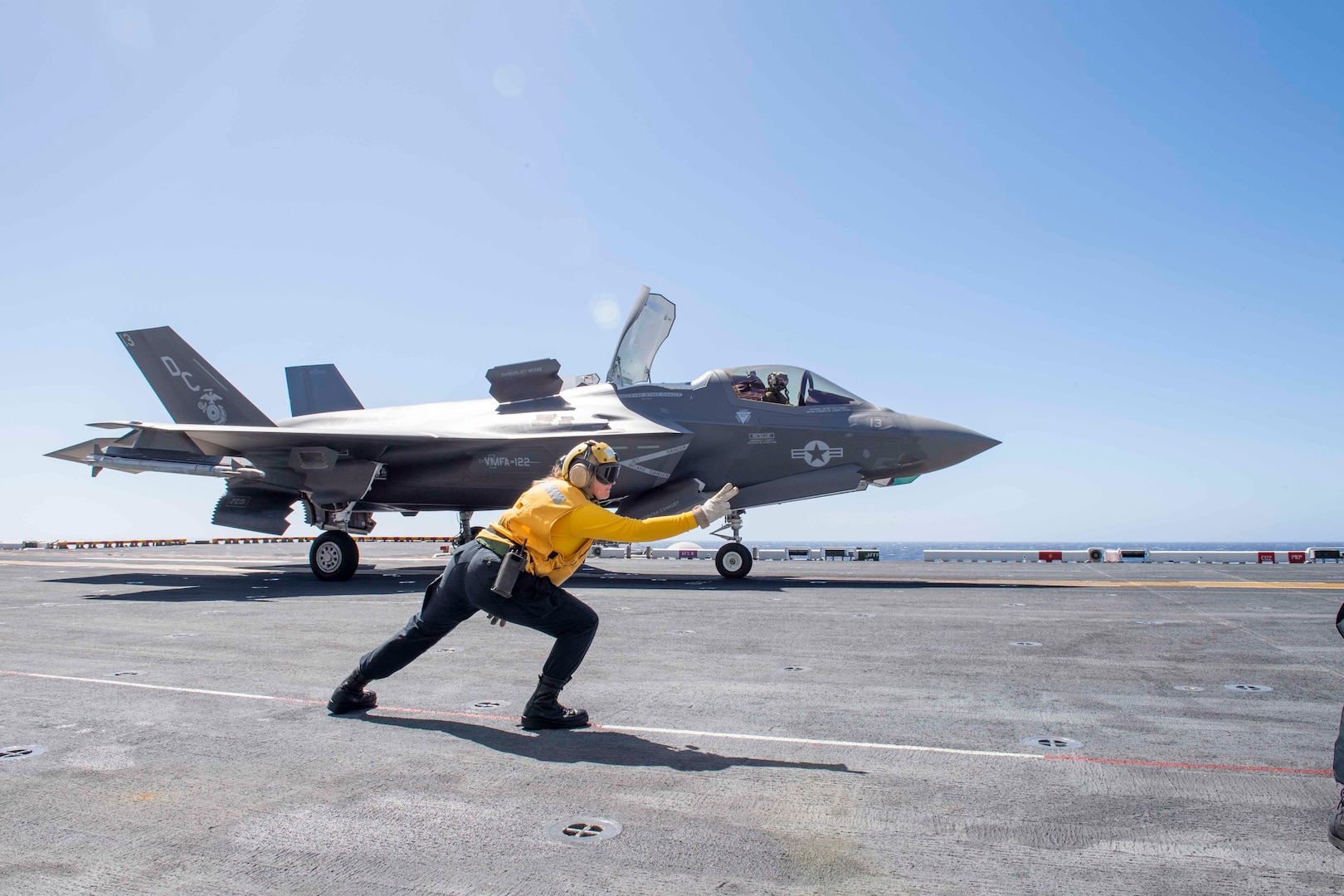 Navy Petty Officer 2nd Class Sabrina Bales, assigned to the amphibious assault ship USS America, signals an F-35B Lightning II from Marine Fighter Squadron 122 to take off from the ship’s flight deck. As the Product Support Provider for North American Regional Warehousing for F-35 spare parts, DLA will help increase the Defense Department’s visibility of inventory as DoD works to decrease sustainment costs and improve readiness. Photo by Navy Petty Officer 3rd Class Vance Hand
