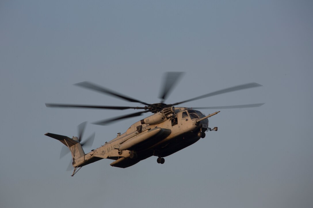 A U.S. Marine Corps CH-53E Super Stallion with Marine Medium Tiltrotor Squadron 365, 26th Marine Expeditionary Unit, performs a cargo lifting drill with Marines from Combat Logistics Battalion 26 on Camp Lejeune, N.C., Oct. 3, 2019. VMM 365 and CLB 26 conducted helicopter support team operations to enhance proficiency and training readiness for the MEU's upcoming deployment at sea. (U.S. Marine Corps photo by Cpl. Nathan Reyes)