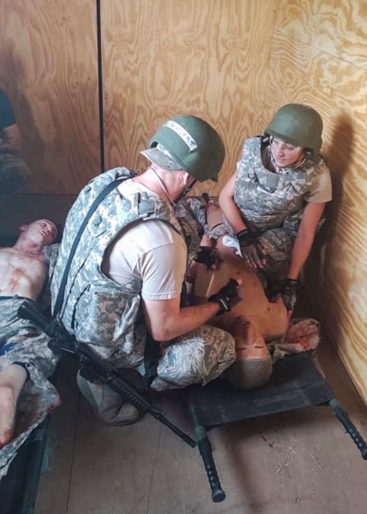 Airman 1st Class Andrew Batchelor, 103rd Medical Group aerospace medical technician, and Senior Airman Kayla Walsh, 103rd Medical Group health services technician, apply Tactical Combat Casualty Care to a patient manikin after a simulated Humvee explosion during the Medic Rodeo at Cannon Air Force Base and Melrose Air Force Range, N.M. Sept. 17-20, 2019. The event, hosted by the 27th Special Operations Medical Group, features 19 Air Force medical technician teams from around the world and trains skills in both deployed and home station scenarios. (U.S. Air National Guard photo)